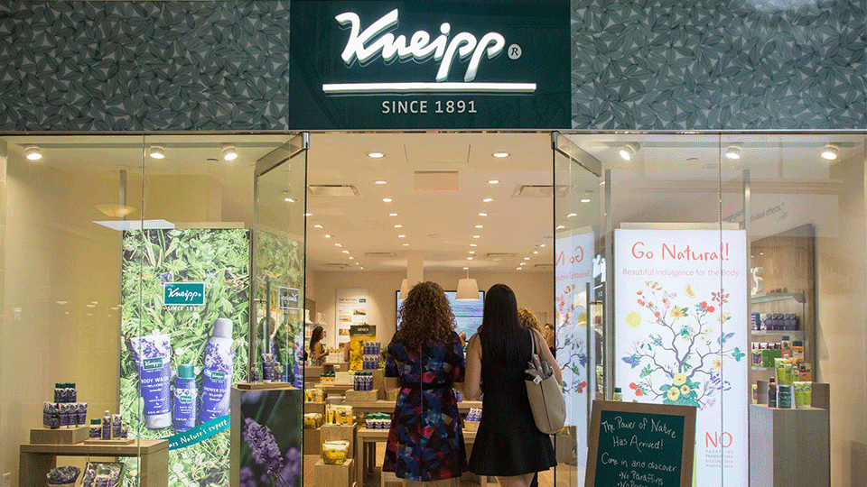 Two shoppers walking into a Kneipp retail store